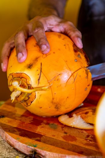 Preparing of a coconut for drinking on a Hikkaduwa market at Sri Lanka